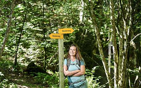 Woman at hiking trail sign