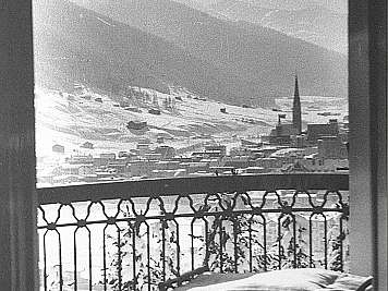 Snow-covered balcony overlooking a mountain town